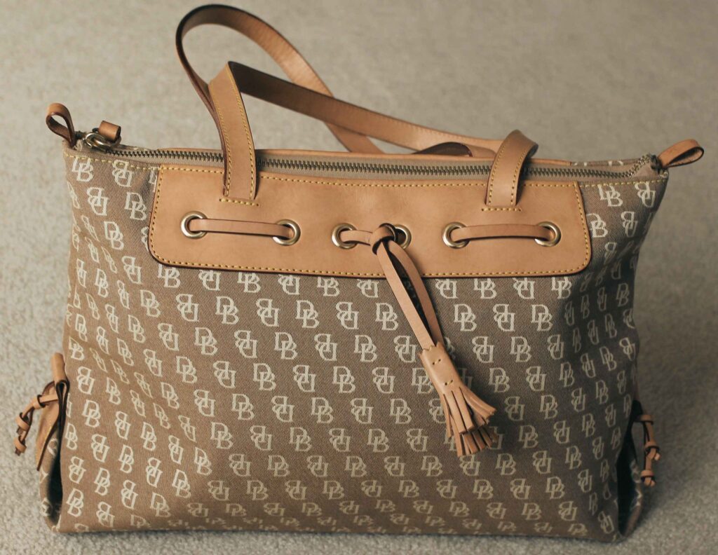 Goyard Saint Louis tote showing natural leather handle patina after regular use