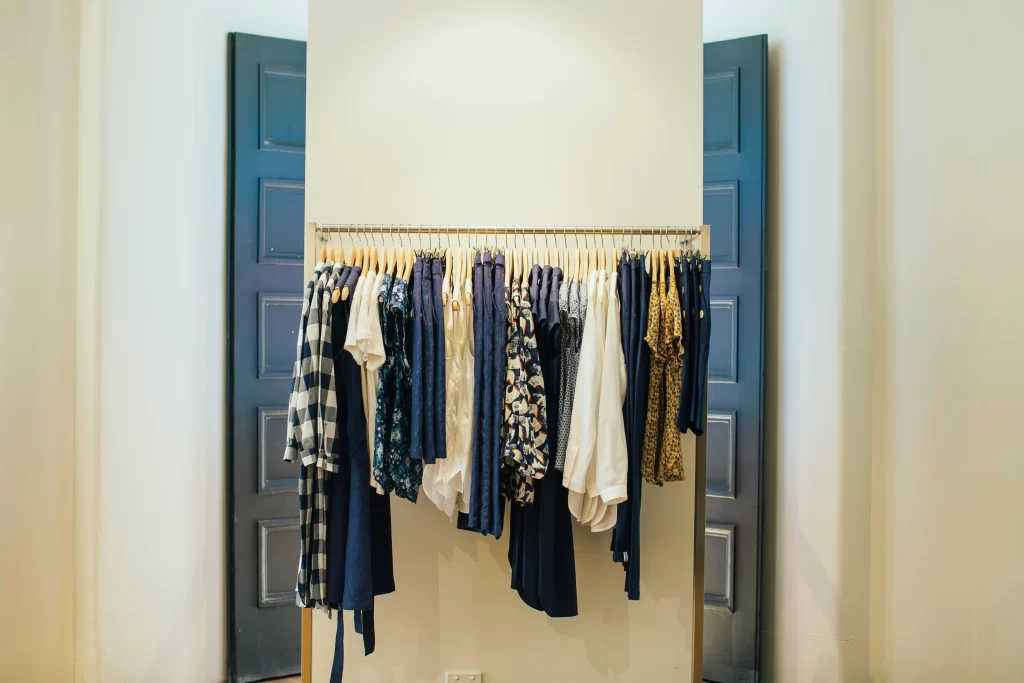 Summer Capsule Wardrobe Over 50: 15 Pieces That Work All Season 4 Organised summer capsule wardrobe for women over 40 and 50 - 15 curated pieces in neutral and accent colours in a wooden wardrobe