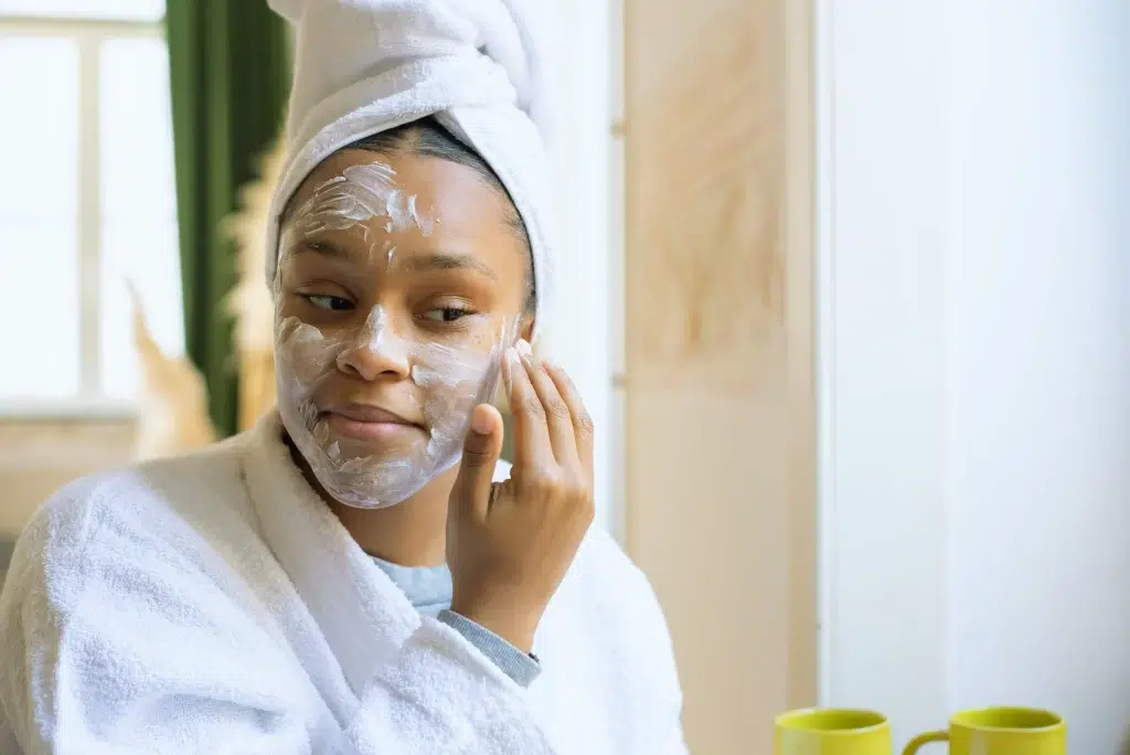 Woman applying night cream as the final step of her evening skincare routine