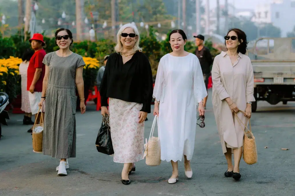 Summer Capsule Wardrobe Over 50: 15 Pieces That Work All Season 3 Women over 40 and 50 wearing summer capsule wardrobe outfits - linen trousers, silk blouse, wrap dress, and denim jacket combinations