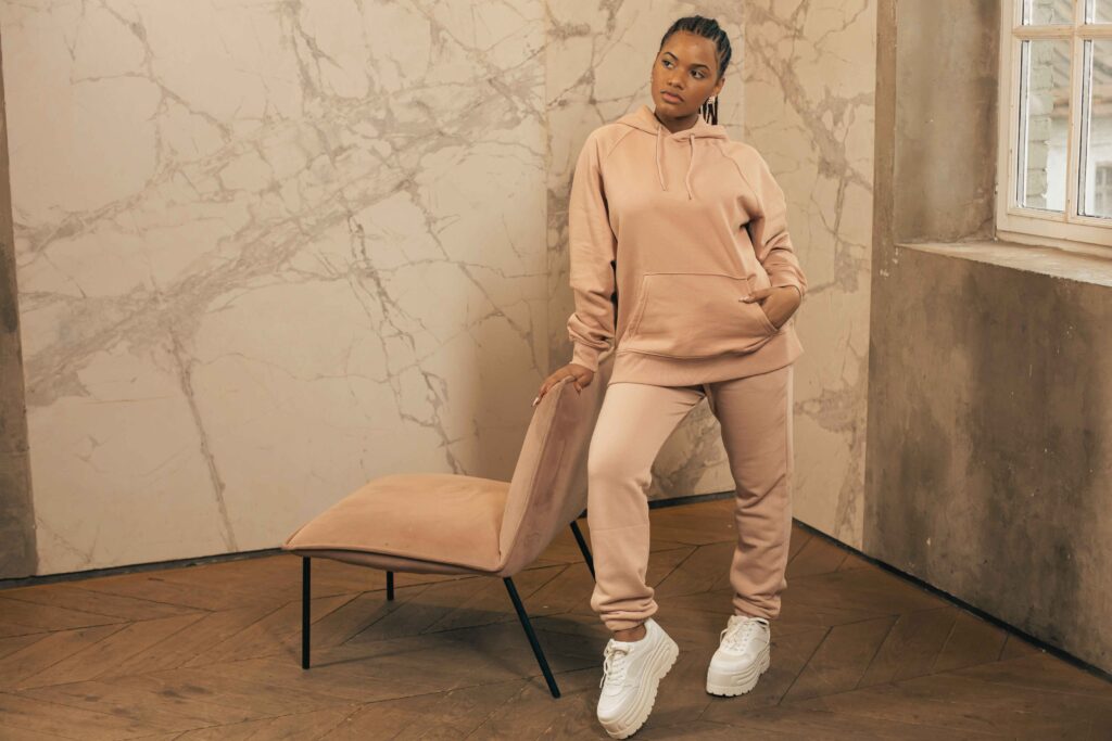 Pink Y2K tracksuit outfit styled with sneakers for a modern retro look