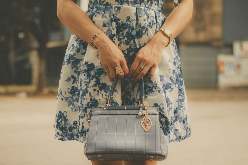 Cobalt blue handbag styled with white and blue dress for a fashion-forward look