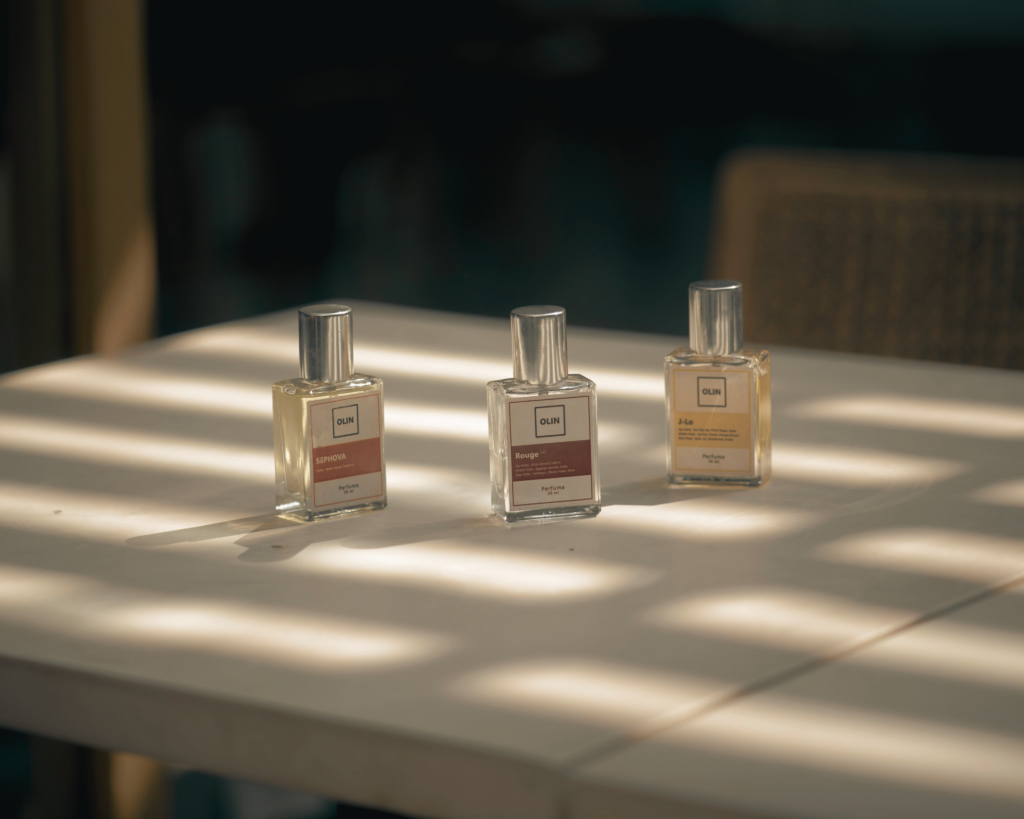Cruelty free eau de parfum dupe bottle next to a designer-style bottle