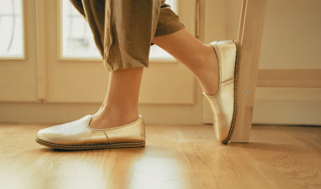 Woman wearing house shoes with arch support for women standing in living room