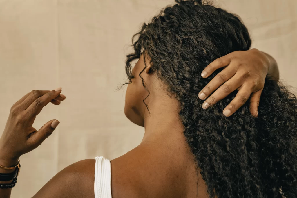 21 Cruelty Free Hair Care Products Worth Your Cart 5 Scrunching cruelty free curl cream into damp curly hair