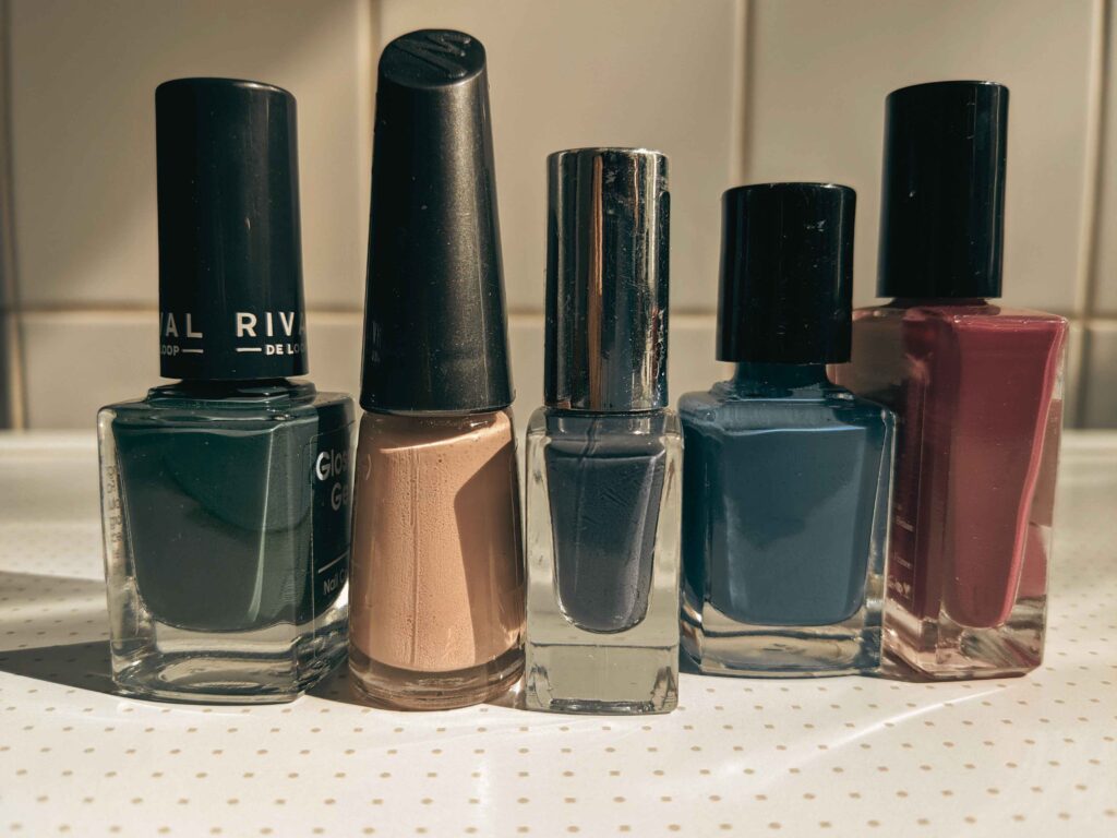 Flat lay of cruelty free nail polish bottles in assorted colors 