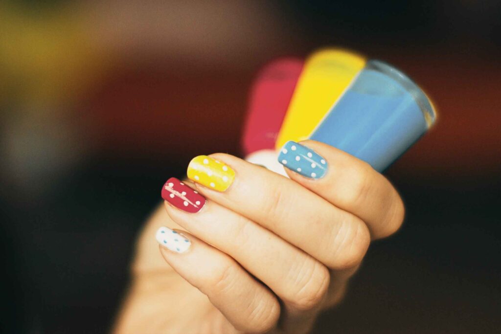 Close-up of hand holding a high-end cruelty free nail polish bottle