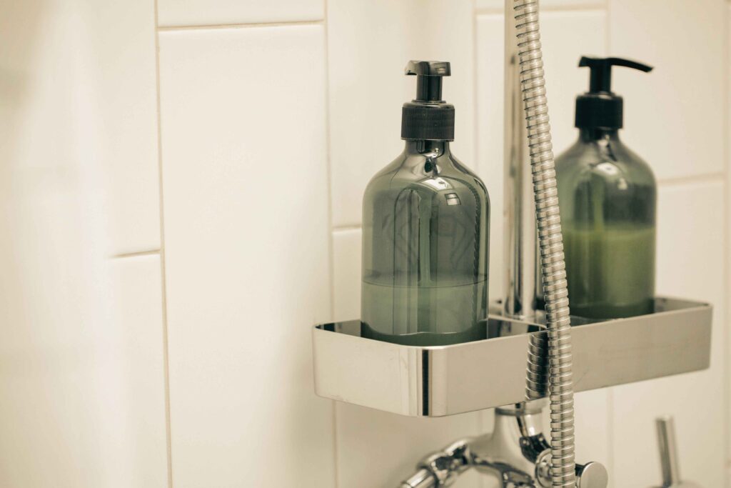 Flat lay of cruelty free shampoo bottles on a bathroom shelf