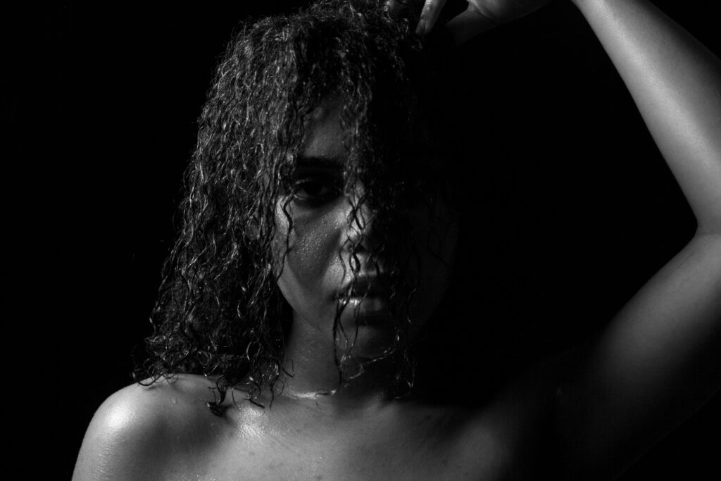 Close-up of curly hair being styled with cruelty free shampoo