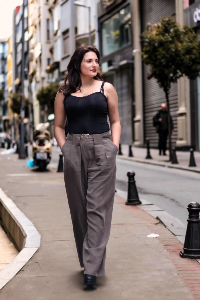 Office Boots for Women: 10 Pairs That Mean Business 3 Woman styling office boots with tailored trousers for a business casual outfit