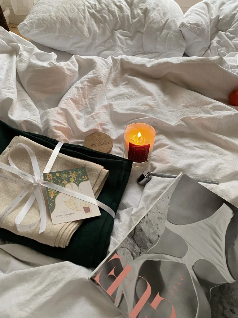 Boutiques Like Francesca's: 8 Similar Style Alternatives 2 Layered gold necklaces, candle and floral blouse flat lay, boutique gifts like those at Francesca's