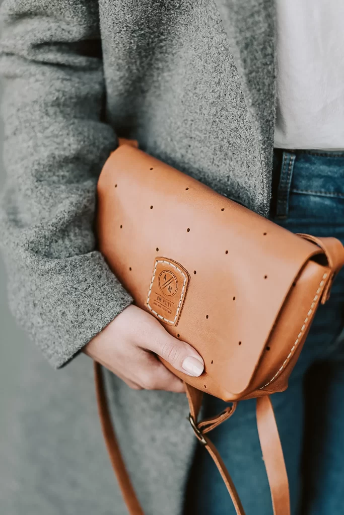10 Best Entry-Level Designer Bags to Buy First 2 Close up of leather texture and stitching on an affordable designer handbag
