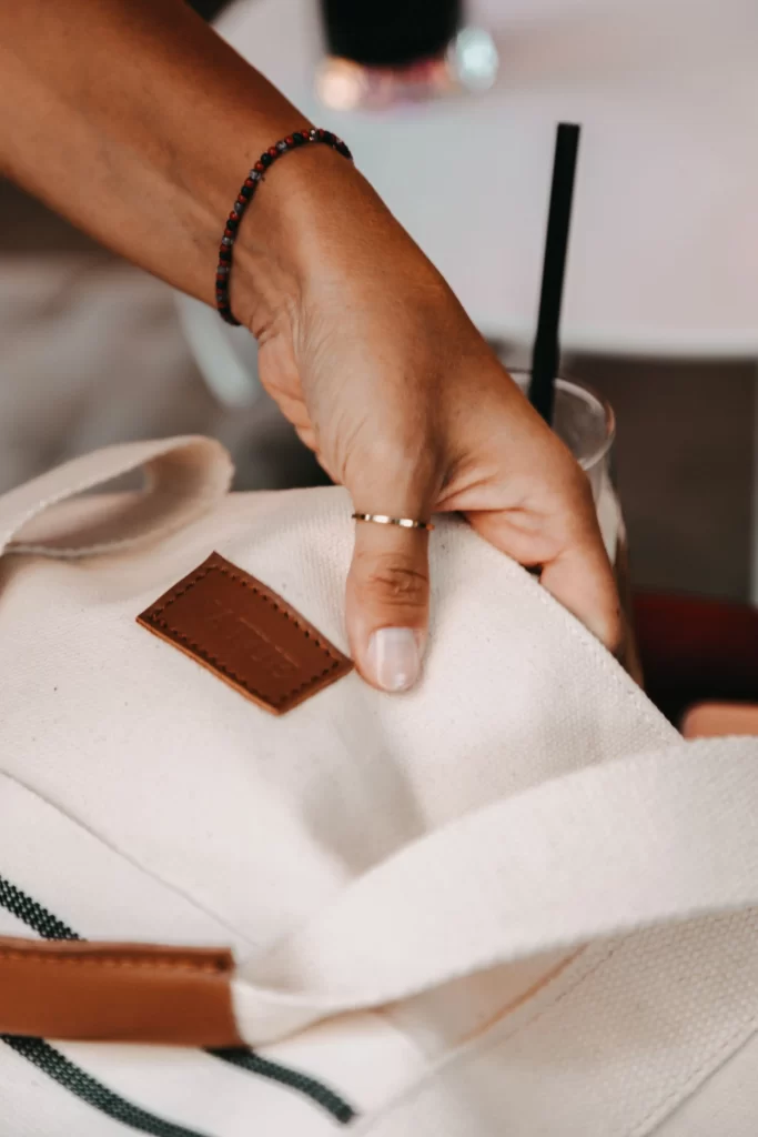 Woman checking a designer bag for signs of a fake before buying it pre owned