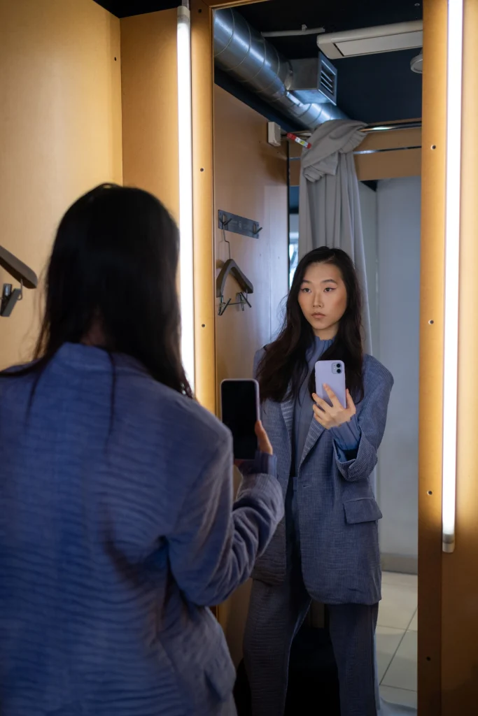 Boutiques Like Chic Soul: 7 Plus Size Style Alternatives 2 Woman trying on a high end plus size clothing blazer in a fitting room