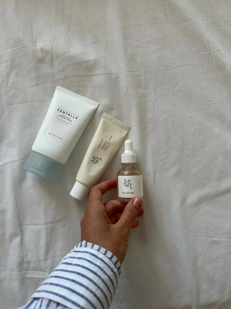 Flat lay of Korean skincare products next to a paper rabbit cutout representing a cruelty free check
