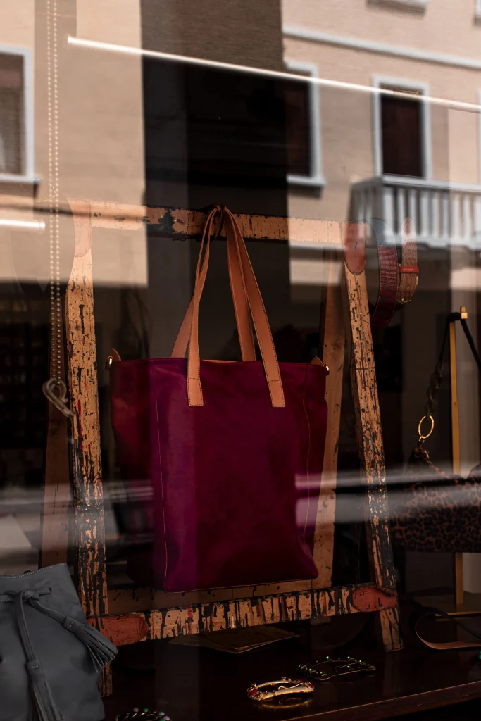 a structured luxury handbag displayed in a boutique window