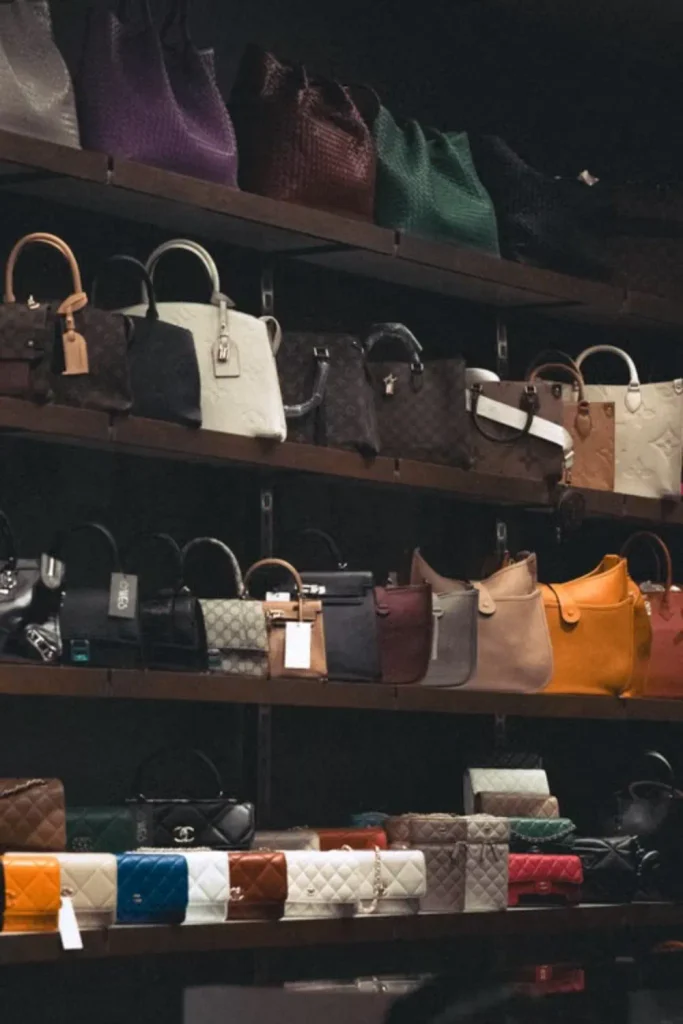 a rack of similar monogram print designer bags at a resale shop