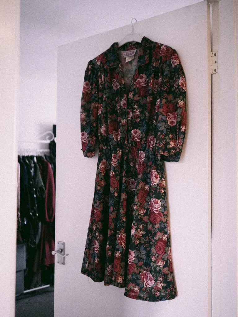 Boutiques Like Francesca's: 8 Similar Style Alternatives 4 Romantic tiered floral midi dress on a hanger, a dressy boutique alternative to Francesca's