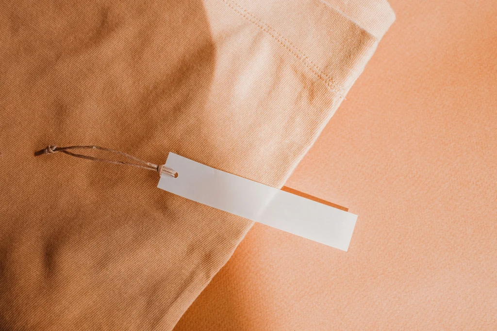 Is VICI Legit? | 7 Similar Boutiques to Try 1 Folded skirt with tag attached beside a phone showing a return QR code