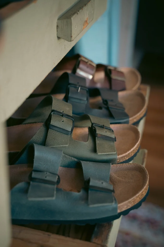 Birkenstock Arizona vs Boston: Which One Fits You Better? 1 Birkenstock Arizona sandal and Boston clog in taupe suede side by side on a neutral surface