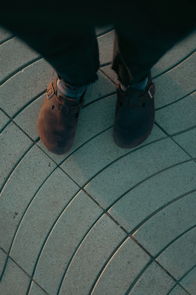 Birkenstock Arizona vs Boston: Which One Fits You Better? 2 Bare foot in a Birkenstock Boston clog with a finger checking the space at the front of the footbed