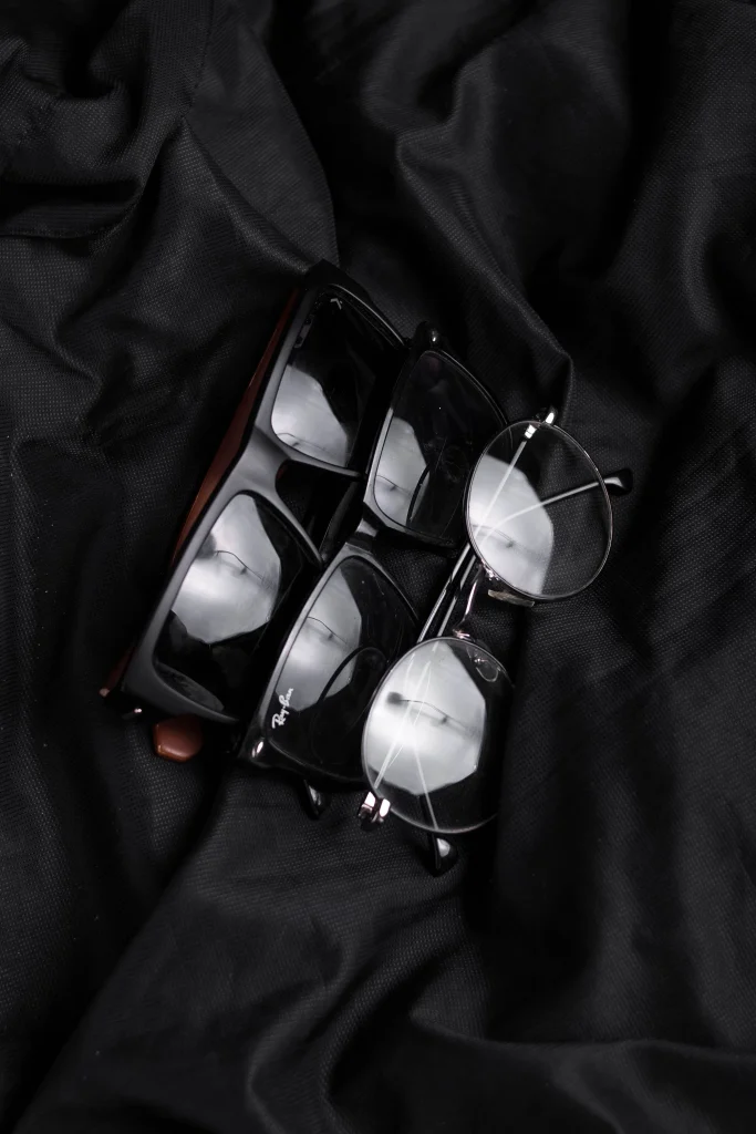 7 Affordable Sunglasses That Look Like Ray-Bans 1 Flat lay of affordable sunglasses in Wayfarer, aviator and round shapes, dupes for Ray Ban